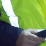 Ein Polizist hält bei einer Verkehrskontrolle ein Alkomat-Messgerät in der Hand.